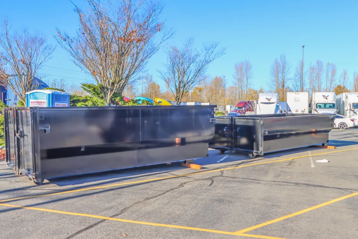 Professional dumpster rental service with roll-off container on residential driveway in Los Banos